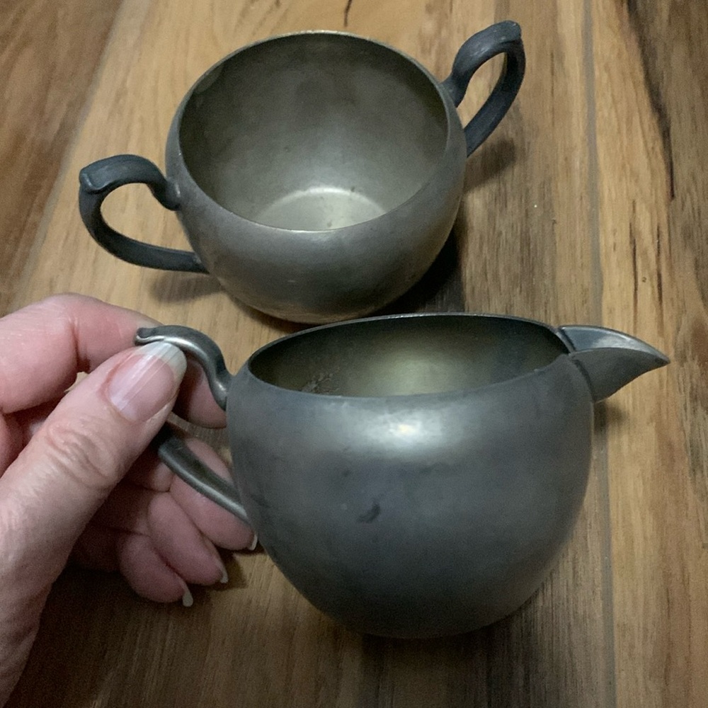 Vintage silver plated creamer and sugar holder set in used condition